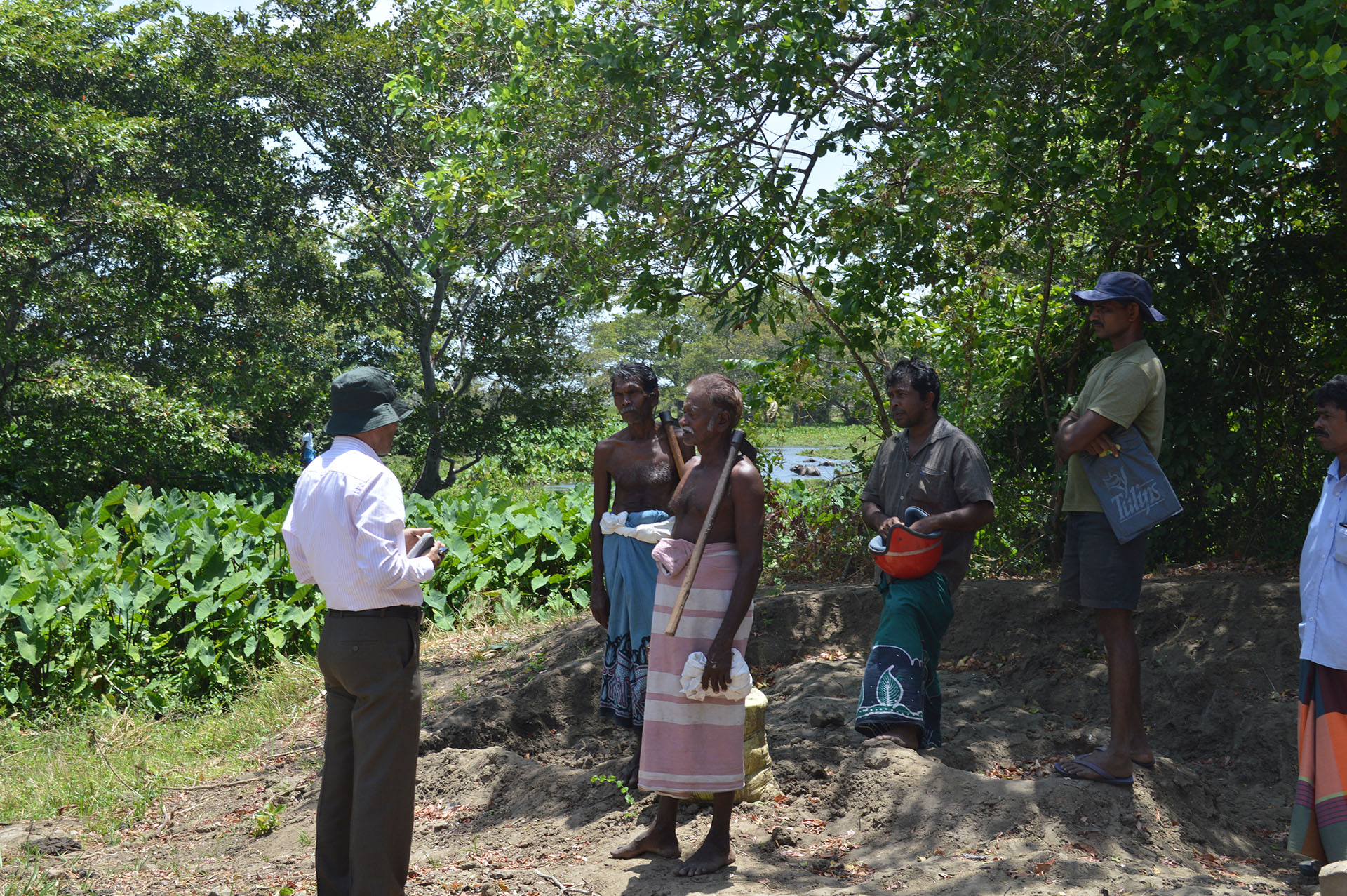 A UN-REDD Programme officer meets a group of indigenous people near their village