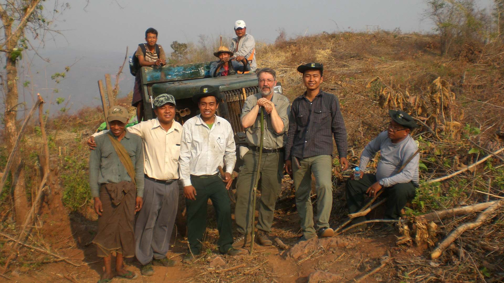 Field crew after finishing data collection with the new NFI field methodology in a cluster of a reserve forest area in Pyin Oo Lwin district, Mandalay region (field crew standing in an open area under shifting cultivation).
